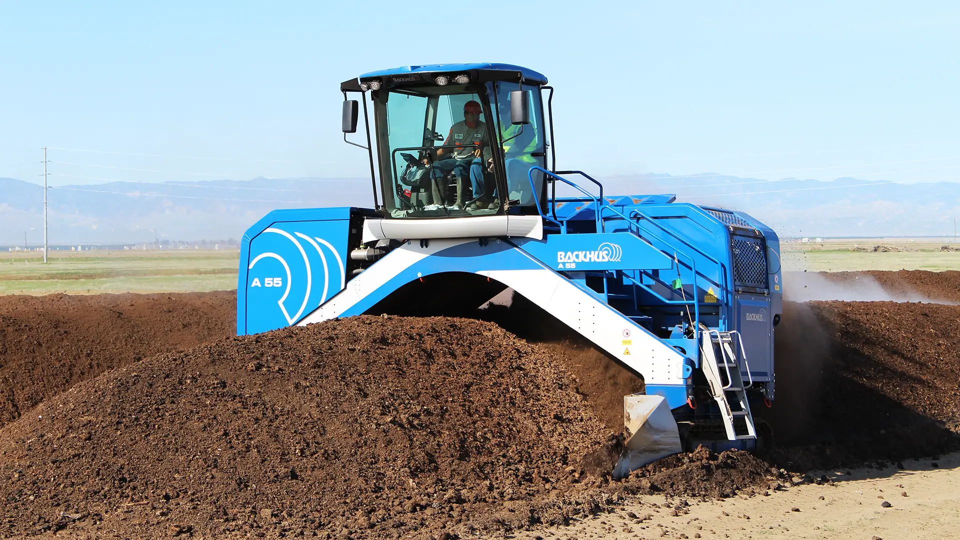 The operator sits in a comfortable enclosed cab high atop BACKHUS compost turners to see what they are doing.