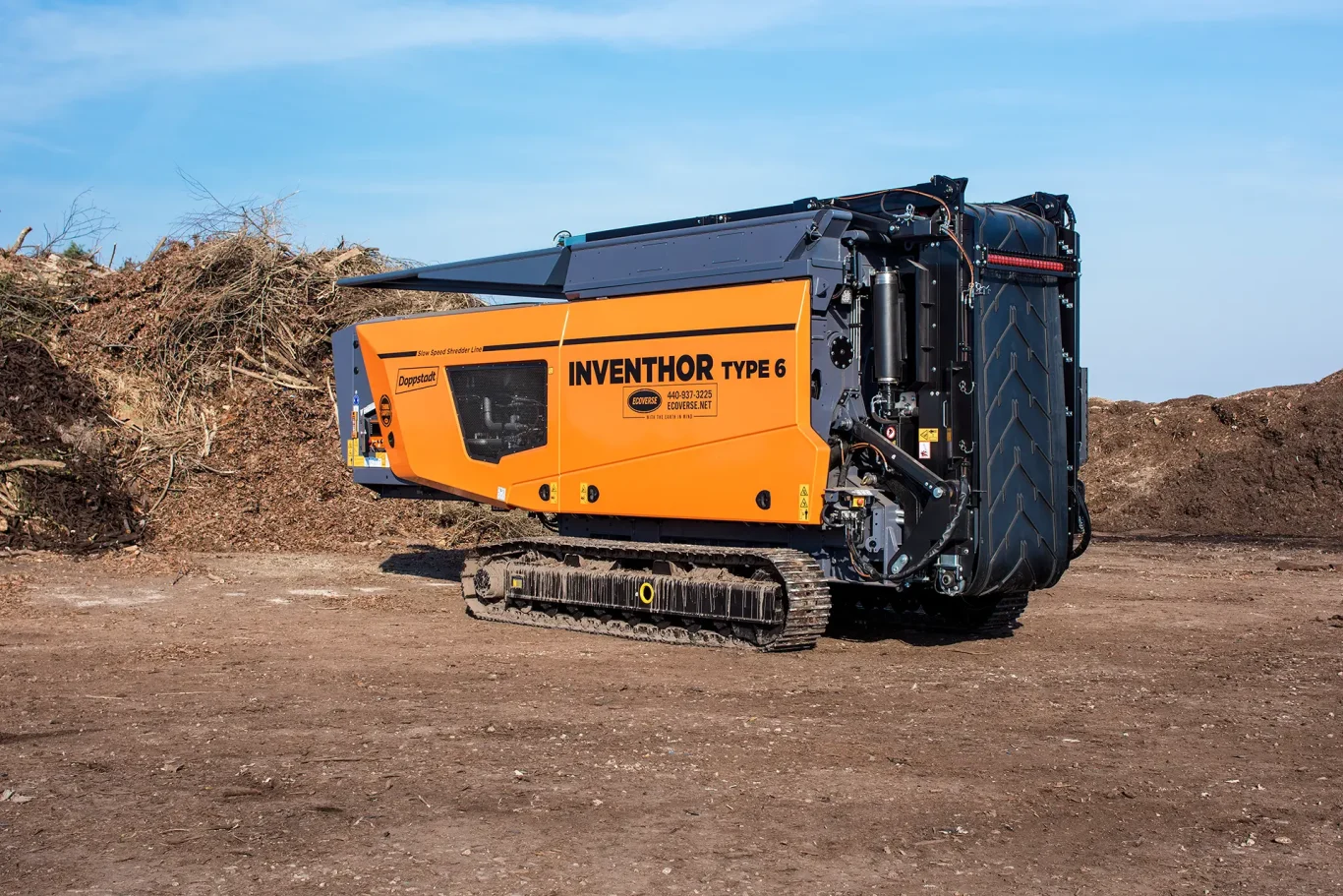 An orange Doppstant INVENTHOR 6 shredder sits in a compost facility in transport position.