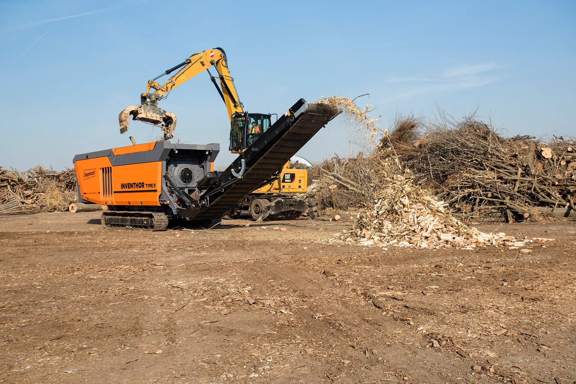 Wood waste is shredded into smaller pieces by a high-torque shredder.