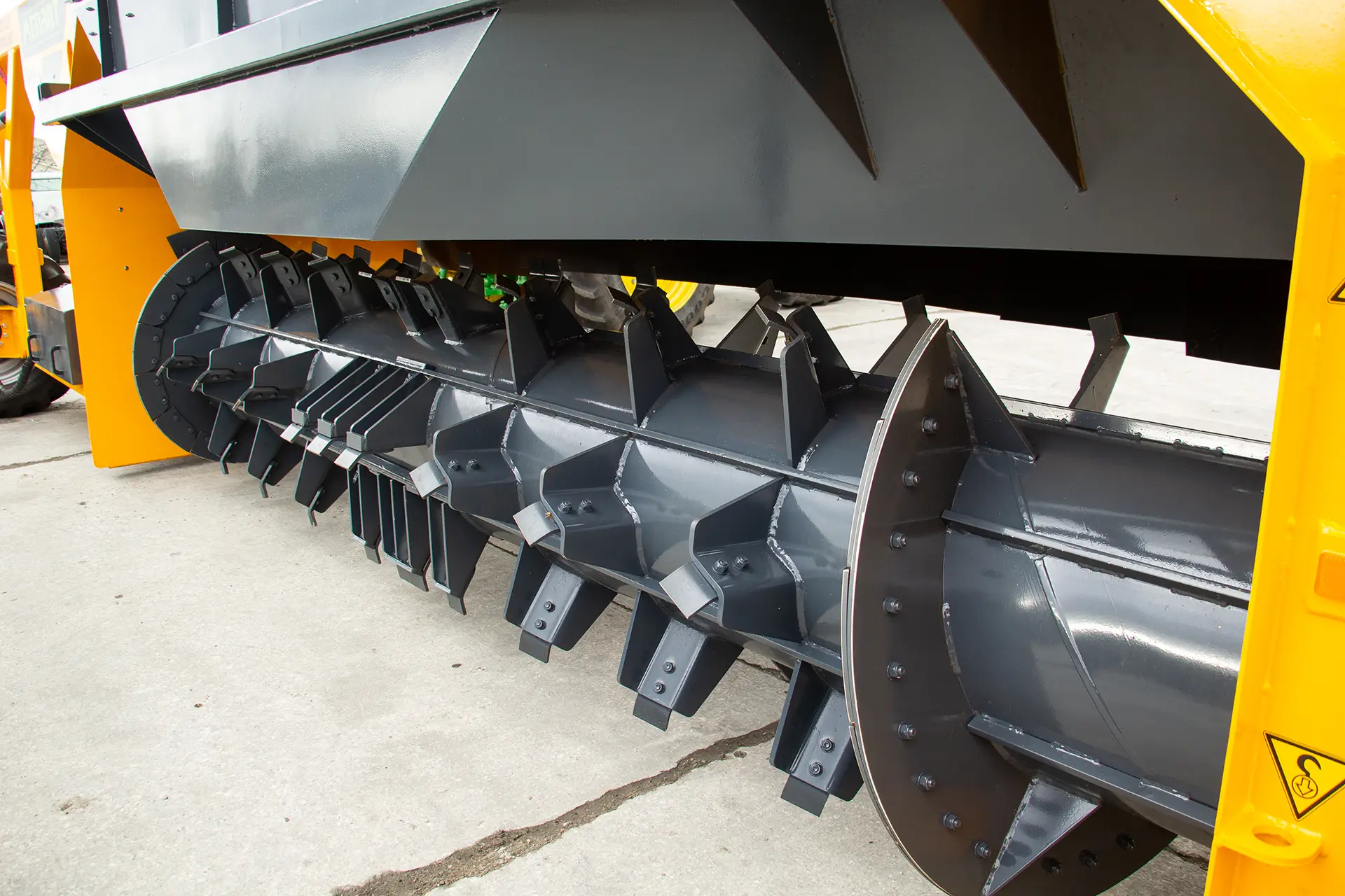 A closeup view of the Menart SP-50 tow-behind compost turner's black steel processing drum.