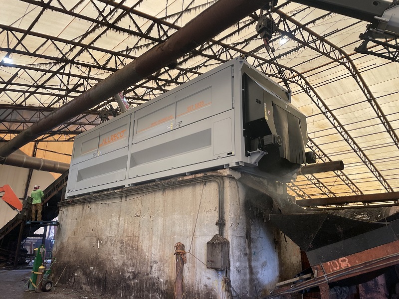 The new enclosed stationary trommel sits in its resting place atop a 12-foot-high concrete bunker.