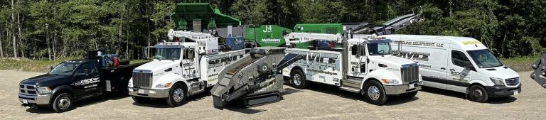 Several trucks from Rock and Recycling are grouped together, side by side.