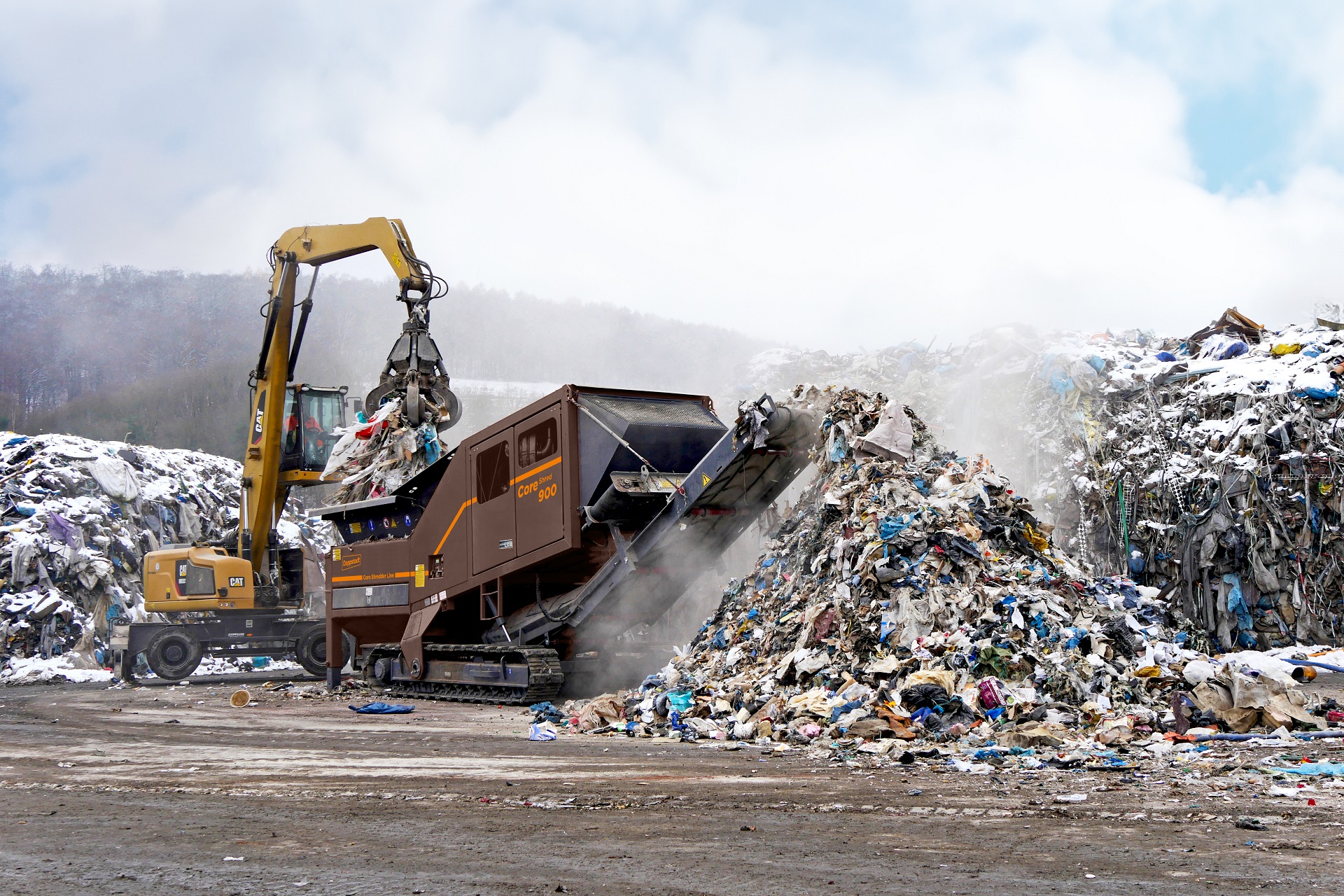 A CoreShred 900 twin-shaft shredder is processing large volumes of municipal solid waste and had created a large pile.