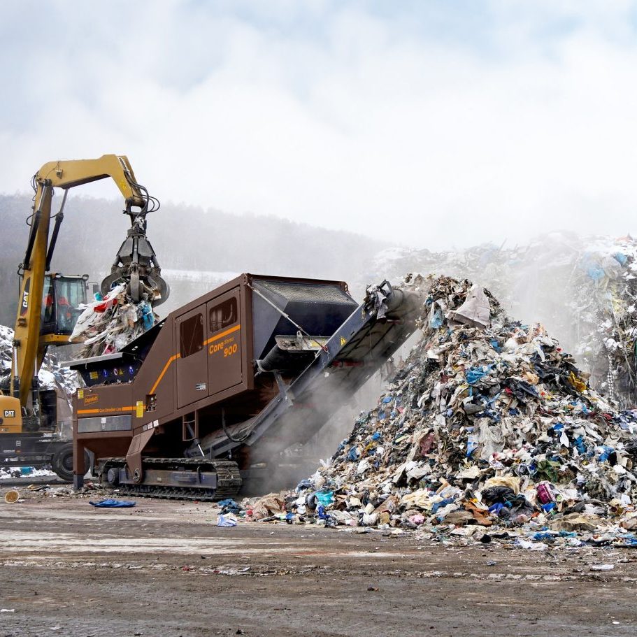 A CoreShred 900 twin-shaft shredder is processing large volumes of municipal solid waste and had created a large pile.