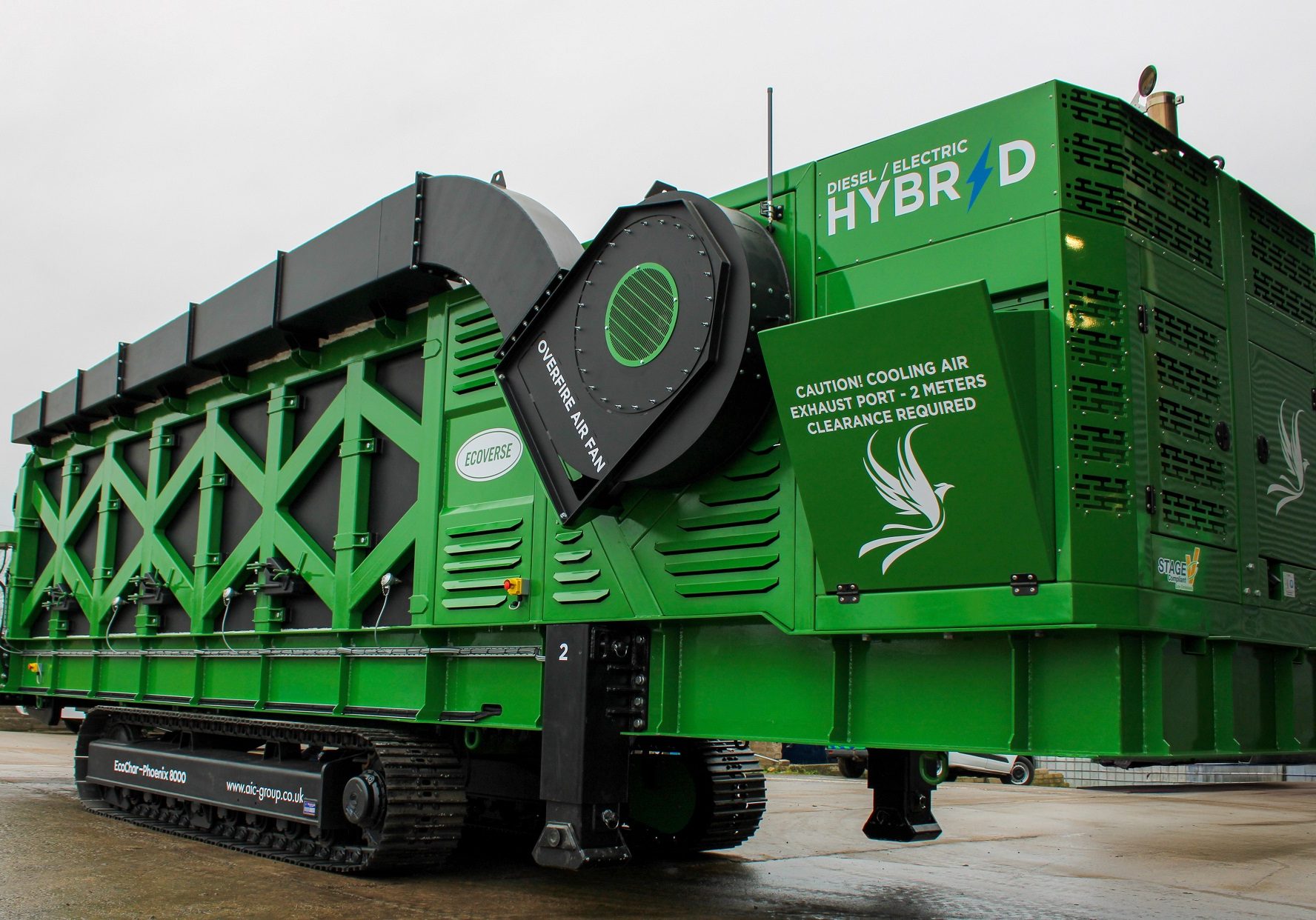 A three-quarters view of the green and black EcoChar Phoenix thermal treatment system machine.