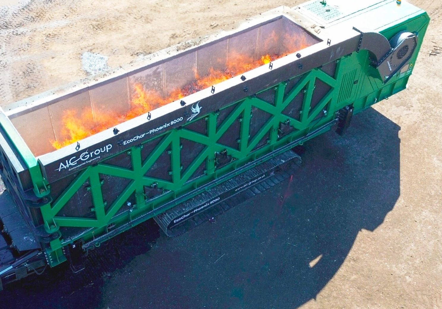 An aerial view of the EcoChar Phoenix thermal treatment system with flames in the combustion chamber.