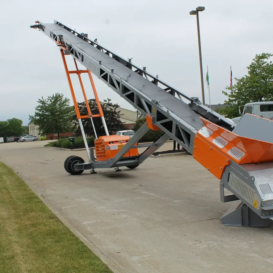 A wheeled EcoStack stacker / conveyor is shown extended to its maximum stacking height.