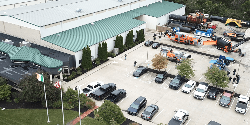 An aerial view shows the Ecoverse headquarters building with environmental processing machines in the adjacent parking lot.