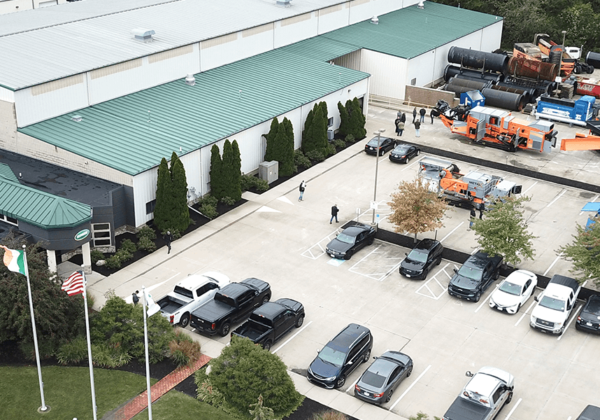 An aerial view shows the Ecoverse headquarters building with environmental processing machines in the adjacent parking lot.