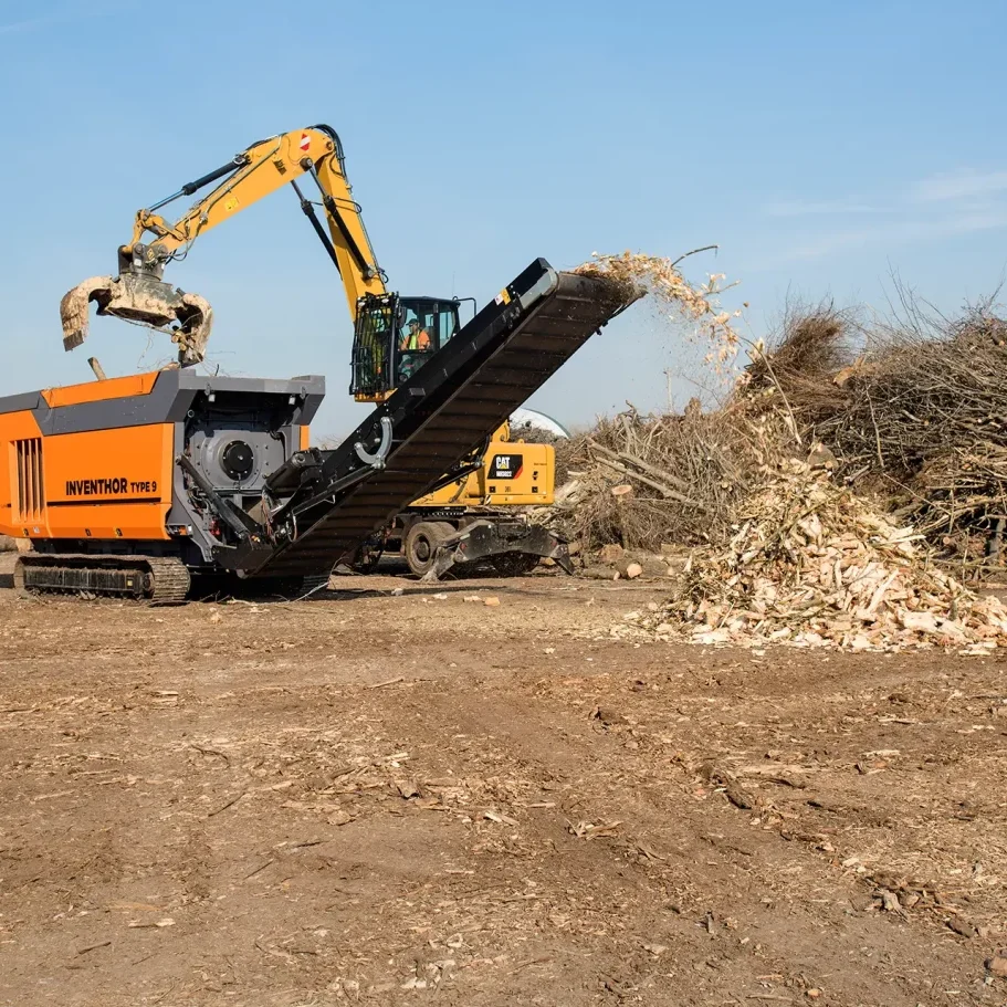 Wood waste is shredded into smaller pieces by a high-torque shredder.