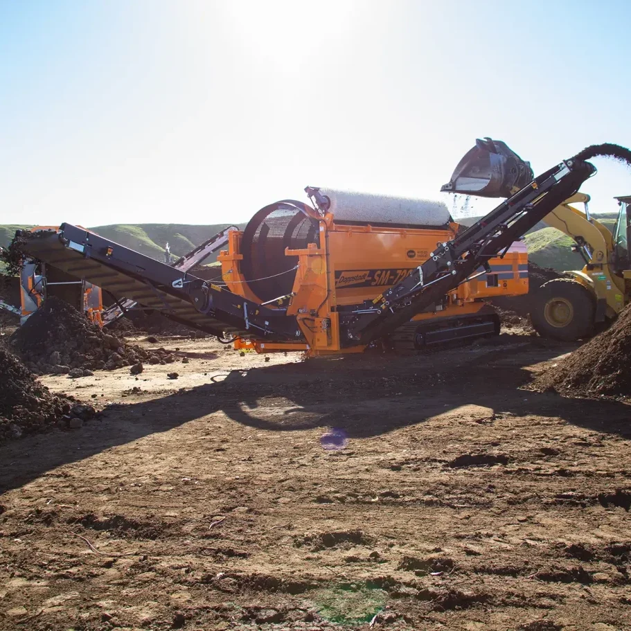 A Doppstant SM 720 trommel screen is loaded with material to be screened and separated.