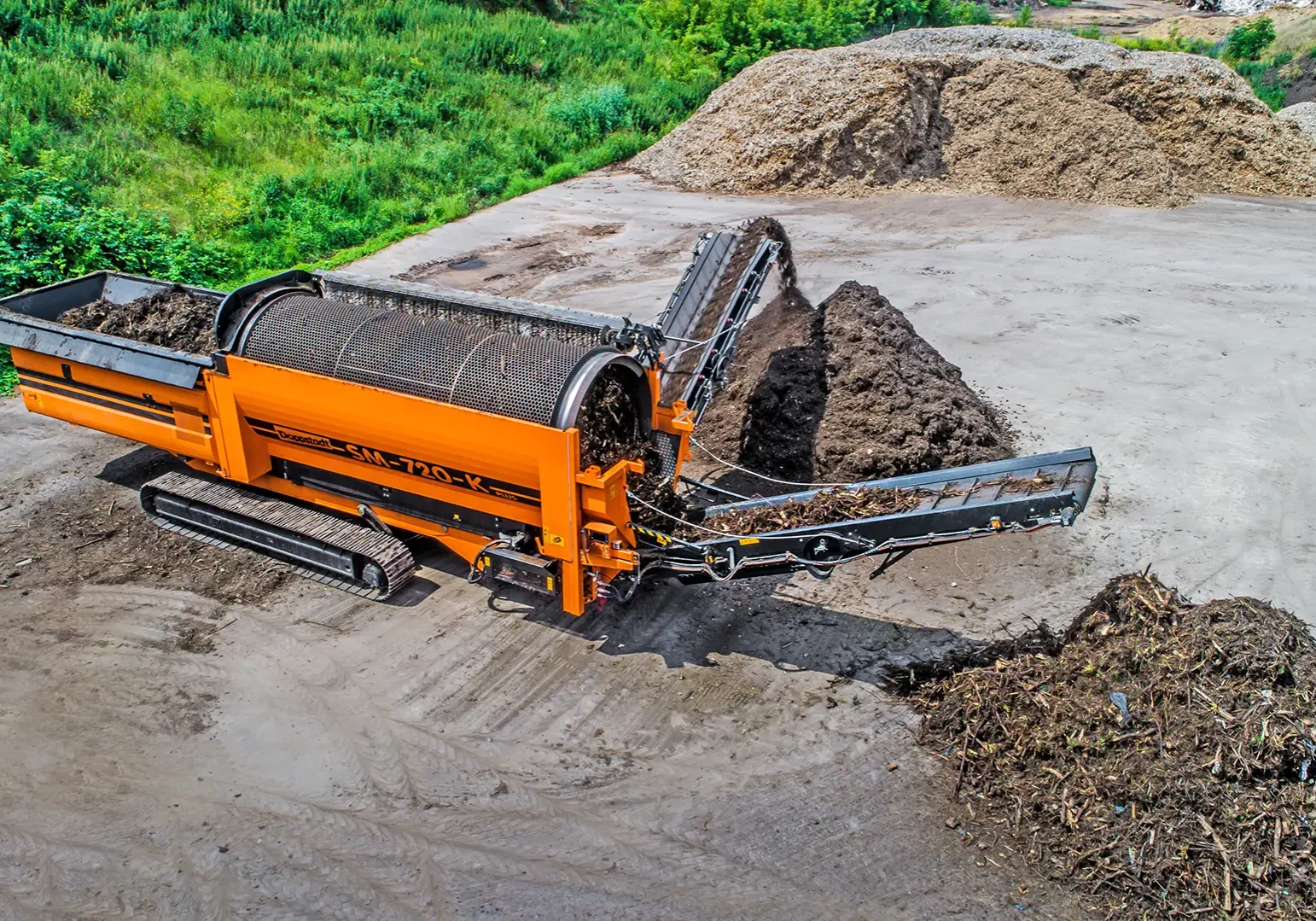 A trommel screen separates wood chips to be processed into biofuel products.